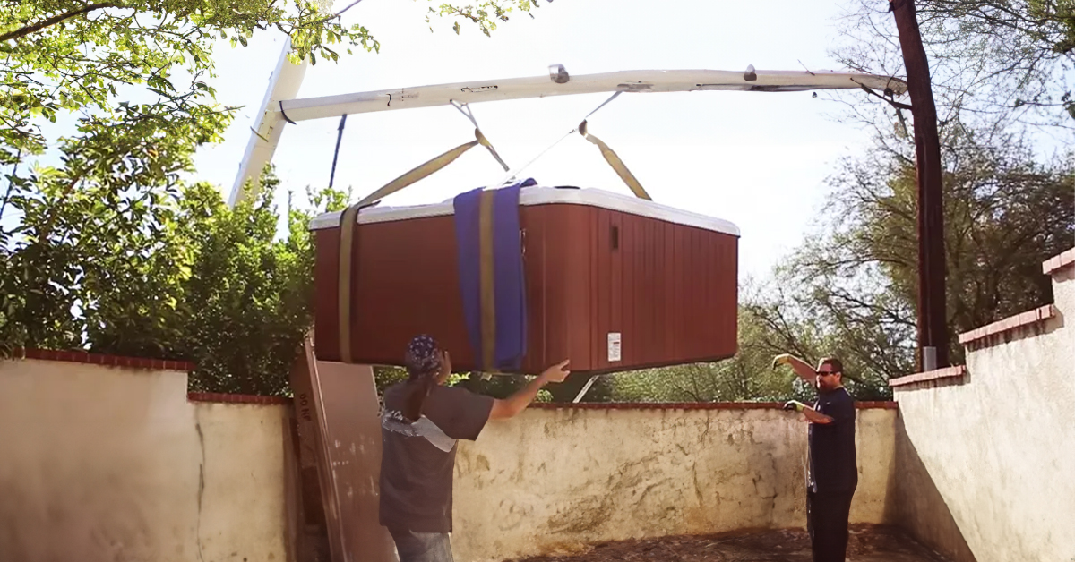 installers lowering a hot tub woth a crane